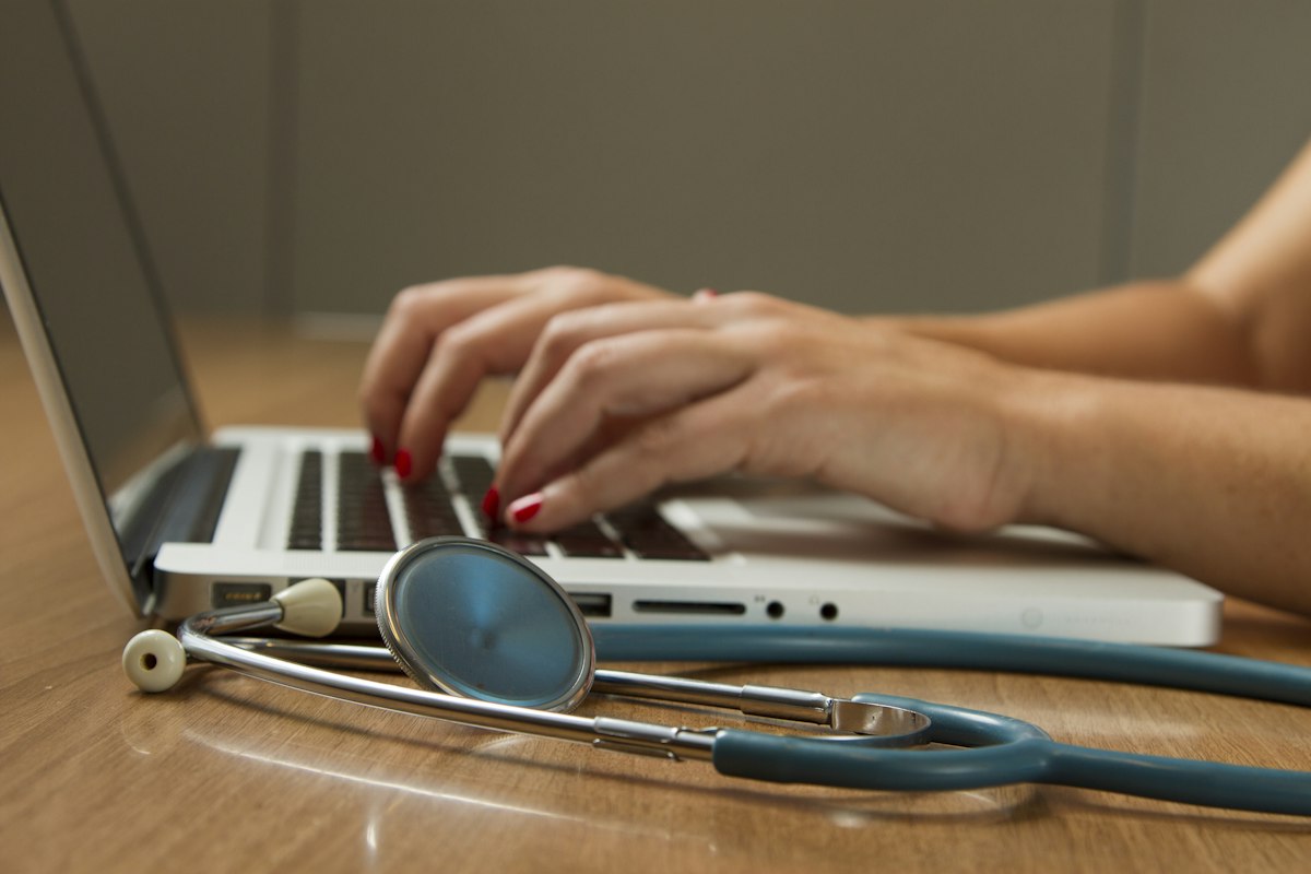 Clinician with a stethoscope in a bright office
